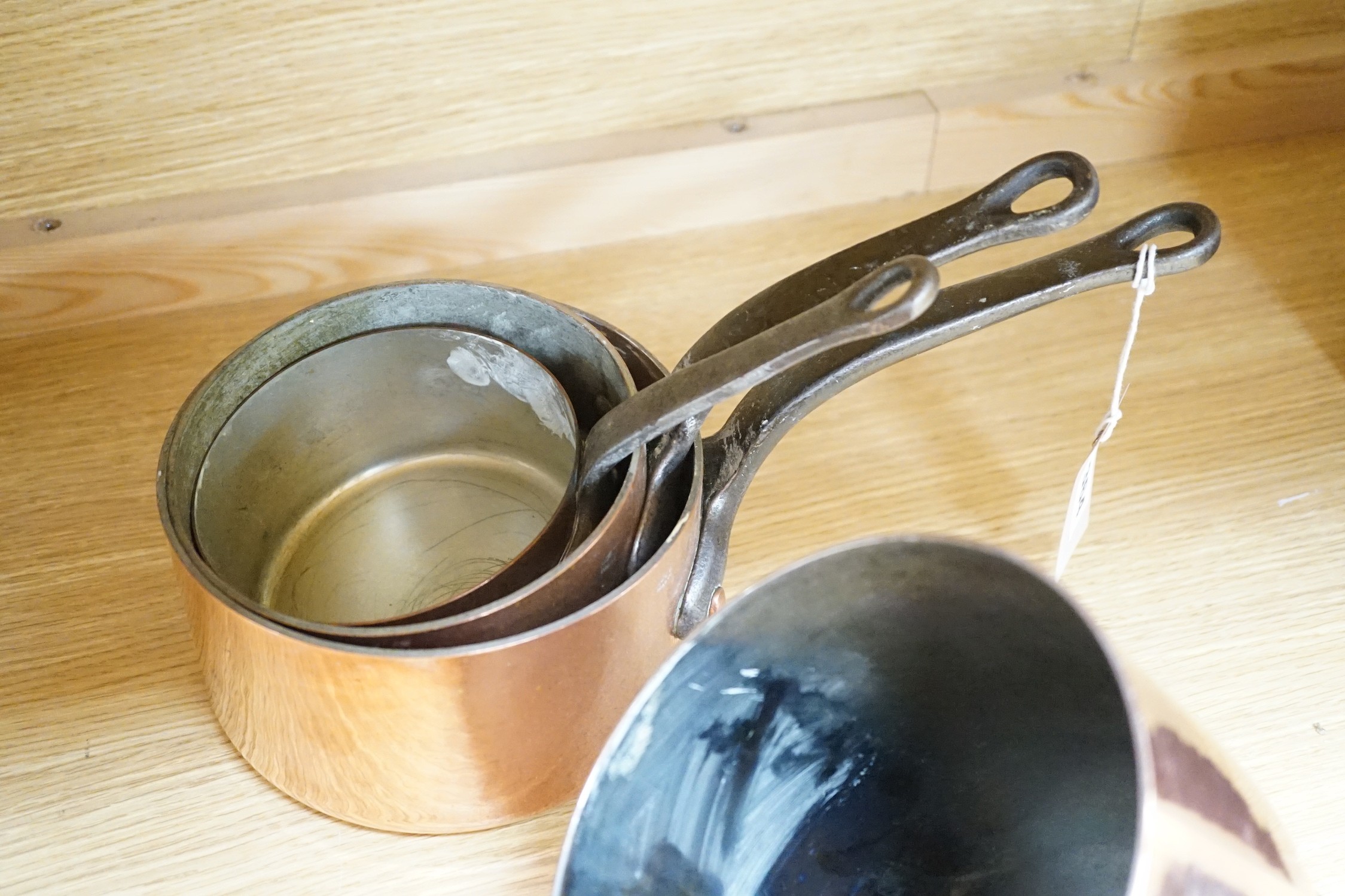 A quantity of copper pans including a zabaglione brass handled pan